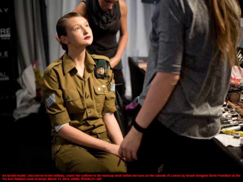 An Israeli model, who serves in the military, wears her uniform