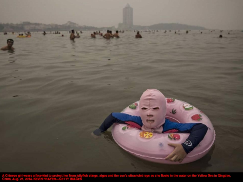 A Chinese girl wears a face-kini to protect her from jellyfish