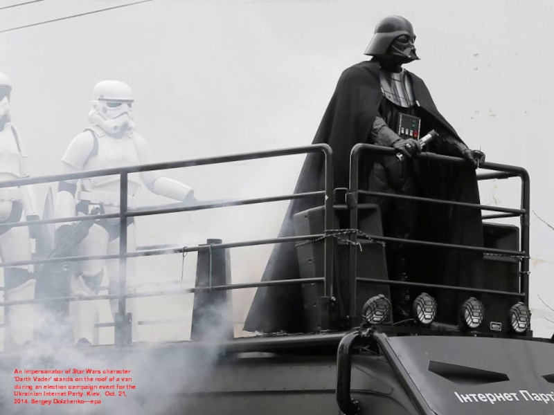 An impersonator of Star Wars character 'Darth Vader' stands on the
