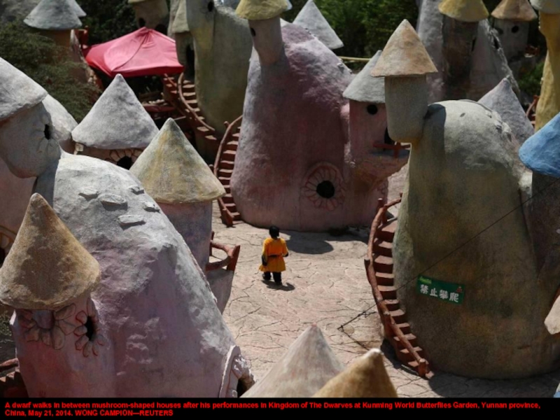 A dwarf walks in between mushroom-shaped houses after his performances in Kingdom