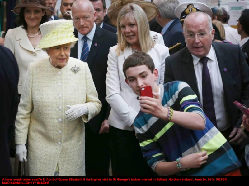 A local youth takes a selfie in front of Queen Elizabeth