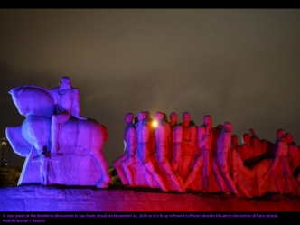 A  man poses at the Bandeiras Monument in Sao Paulo, Brazil, on November 14, 2015 as it is lit up in France's official colors in tribute to the victims of Paris attacks.
Rodolfo Burher / Reuters