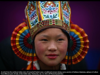 An artist from the northeast Indian state of Arunachal Pradesh wears a traditional costume during a press preview of tableaux displaying a glimpse of culture from different parts of India, in New Delhi, India, Wednesday, Jan. 22, 2014. (AP Photo/Saurabh D
